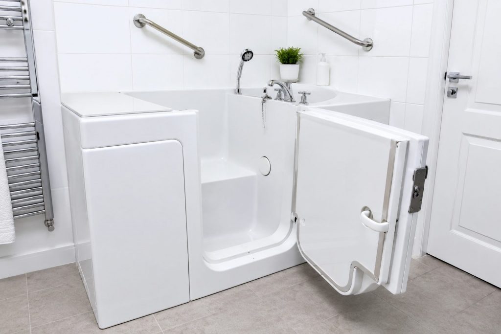 White walk-in bath with side door open showing interior seat and grab rails